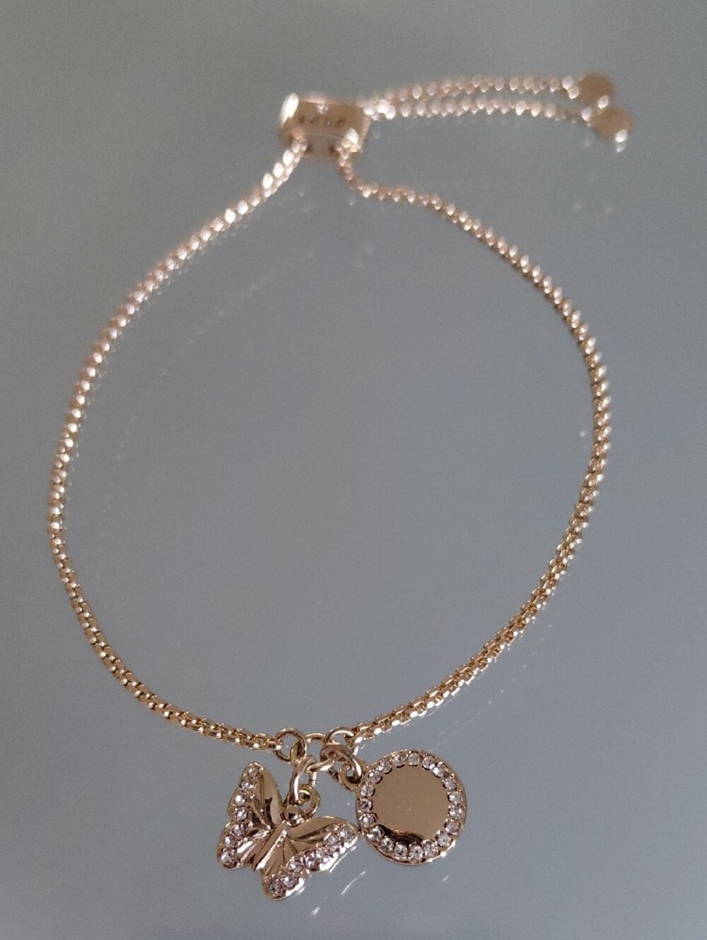 DKNY Gold Tone Adjustable Butterfly Charm Bracelet | Pavé Crystal